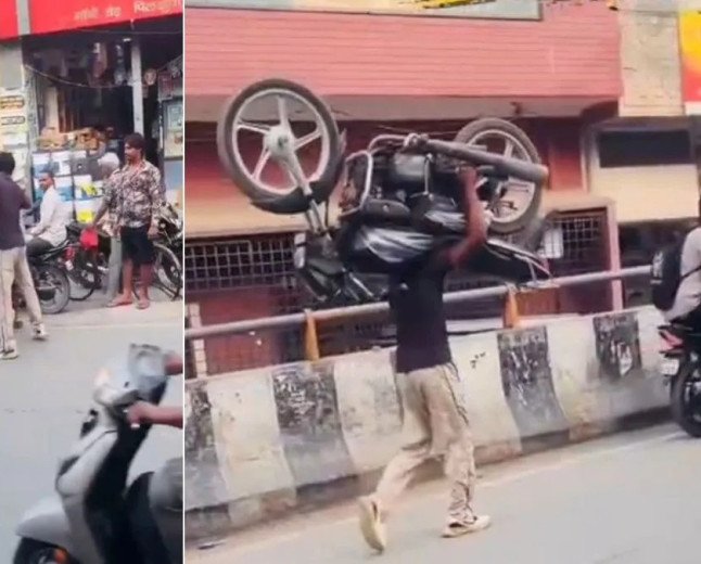 Hapur youth walks on busy road carrying bike on shoulder for reel
